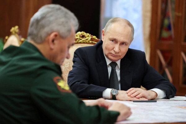 Russian President Vladimir Putin listens to Defense Minister Sergei Shoigu during a meeting in Moscow on Feb. 20, 2024. (Sputnik/Alexander Kazakov/Pool via Reuters)
