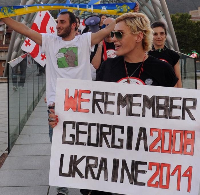 Protesters hold posters and shout slogans at a rally in support of Ukraine and against Russian President Vladimir Putin in Tbilisi, Georgia, on Aug. 26, 2014. (Vano Shlamov/AFP/Getty Images)