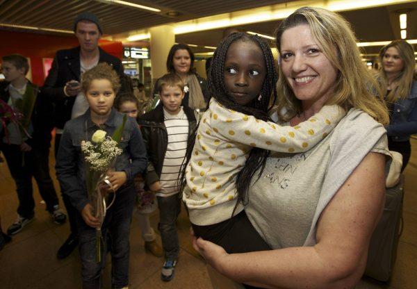 Belgian Laurence Senechal (R) arrives at Brussels National Airport in Zaventem from Kinshasa on Aug. 31, 2014, where she was greeted by her adopted daughter, Imany. (Nicolas Maeterlink/AFP/Getty Images)