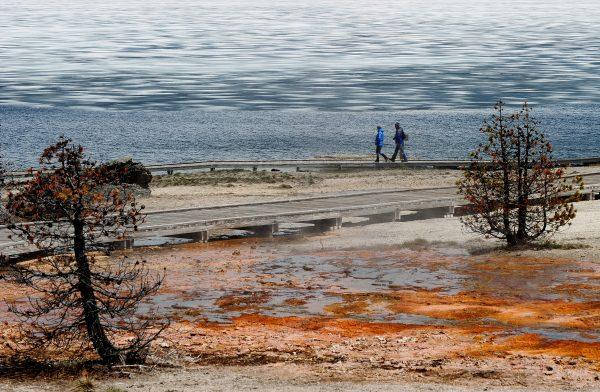 Tourists walk beside Yellowstone Lake at the West Thumb Geyser Basin in the Yellowstone National Park, Wyoming on June 2, 2011. (Mark Ralston/AFP/Getty Images)