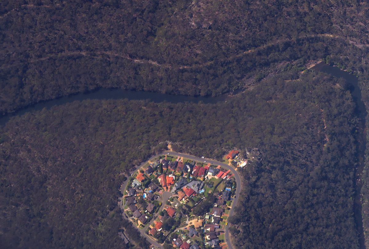 Homes can be seen near a river and bordering bushland in south-western Sydney, Australia, Dec. 7, 2017. (Reuters/David Gray)