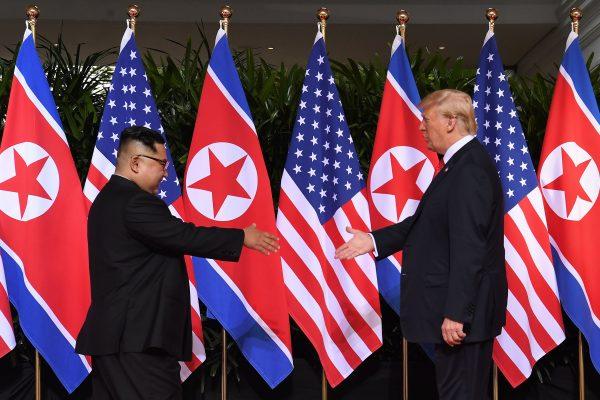 North Korea's leader Kim Jong Un (L) with President Donald Trump at the start of their historic summit, at the Capella Hotel on Sentosa island in Singapore on June 12, 2018. (Saul Loeb/AFP/Getty Images)