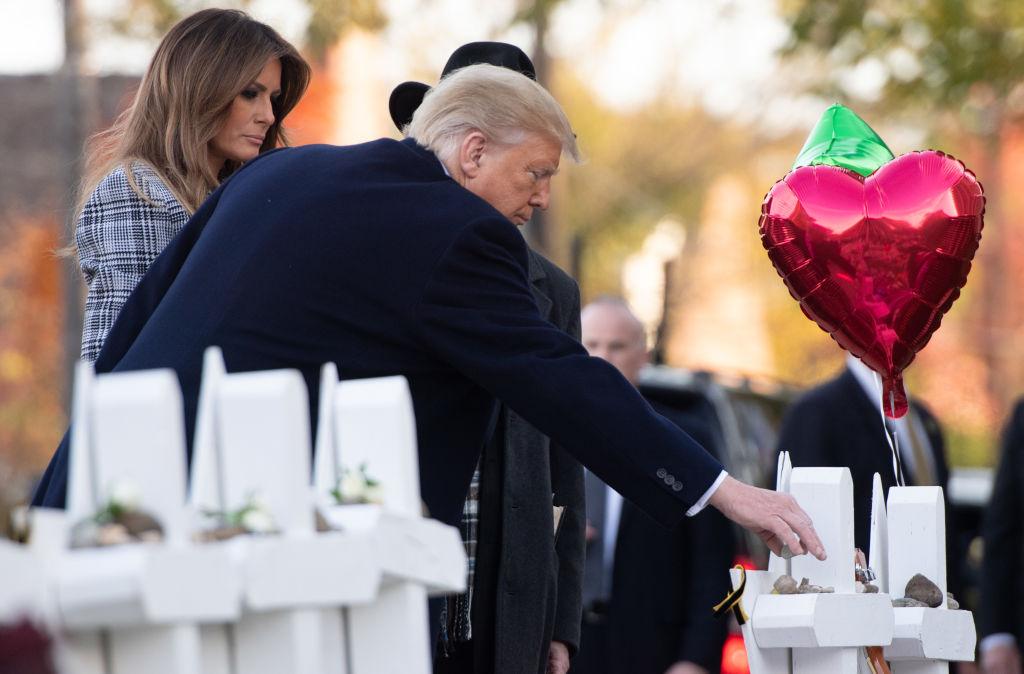 President Donald Trump and First Lady Melania Trump, alongside Rabbi Jeffrey Myers, place stones and flowers on a memorial as they pay their respects at the Tree of Life Synagogue in Pittsburgh, Pa., on Oct. 30, 2018. (Saul Loeb/AFP/Getty Images)
