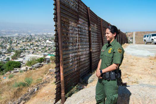 San Diego Border Patrol agent Tekae Michael at the eastern end of the U.S.-Mexico border barrier in Otay Mesa, San Diego, on July 12, 2017. The section of border wall was first constructed in 1991 to prevent vehicles from illegal crossings. (Joshua Philipp/The Epoch Times)