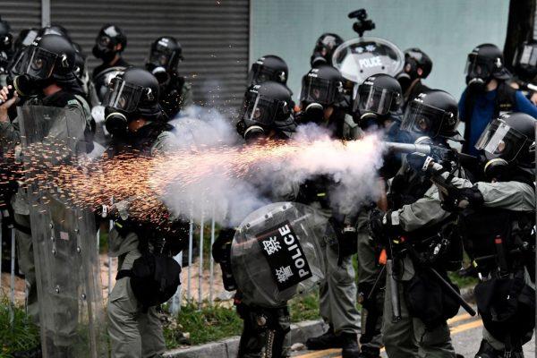 A policeman fires tear gas to disperse protesters during a demonstration in the district of Yuen Long in Hong Kong on July 27, 2019. (Anthony Wallace/AFP/Getty Images)