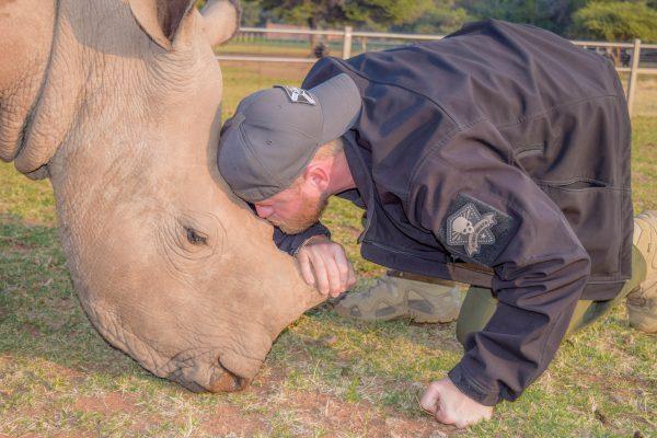 Ryan Tate with a rhino. (Courtesy of Veterans Empowered to Protect African Wildlife)