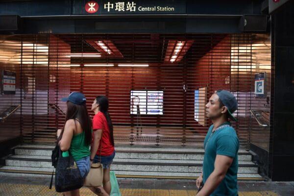 Pedestrians walk past the shuttered underground MTR rail station in the Central district in the afternoon in Hong Kong on Oct. 5, 2019. (Nicolas Asfouri/AFP via Getty Images)