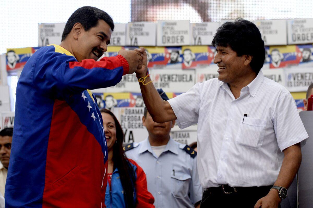 Venezuelan President Nicolás Maduro (L) and Bolivian President Evo Morales greet each other during a rally at the Miraflores presidential palace in Caracas on April 9, 2015. (FEDERICO PARRA/AFP/Getty Images)