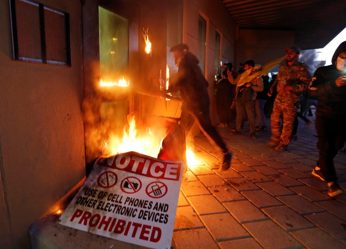 Protesters and militia fighters set fire to a reception room of the U.S. Embassy during a protest in Baghdad, Iraq, on Dec. 31, 2019. (Wissm al-Okili/Reuters)