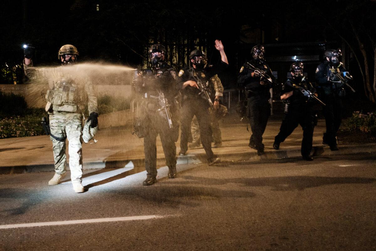 Federal officers use tear gas and other crowd dispersal munitions on violent demonstrators in Portland, Ore., on July 17, 2020. (Mason Trinca/Getty Images)