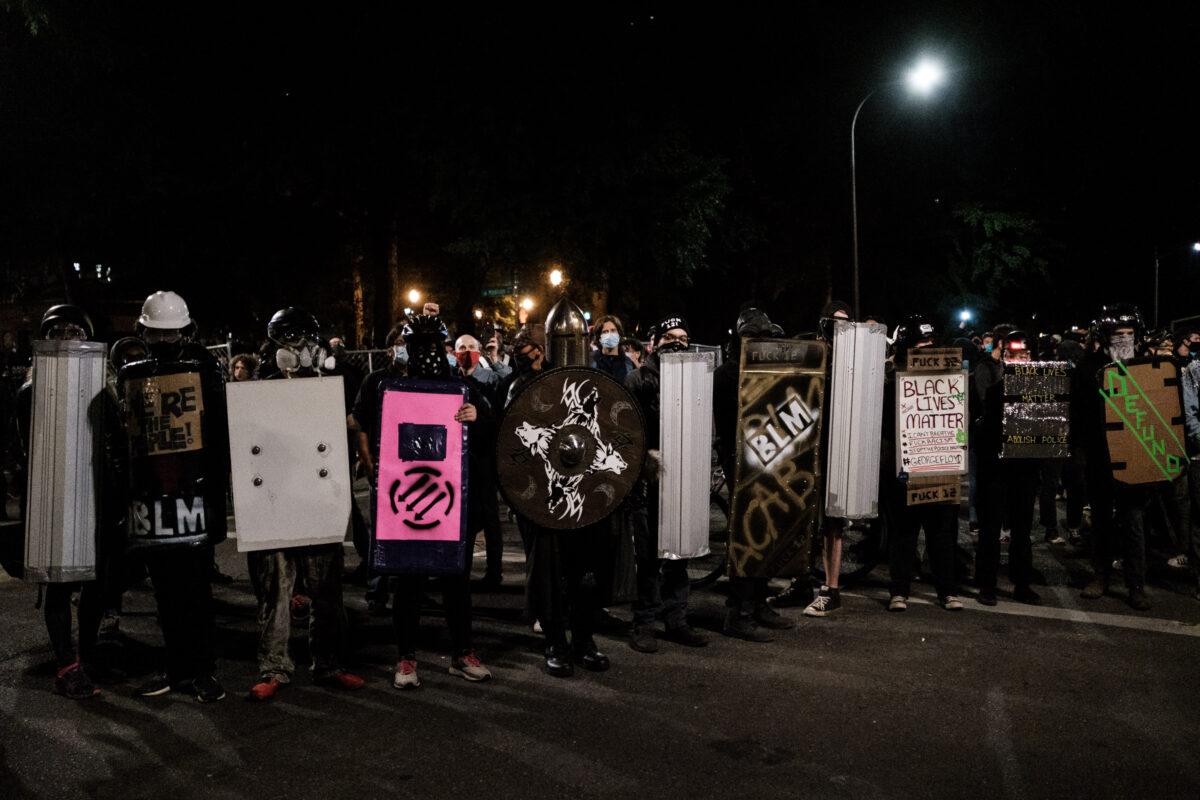 Demonstrators with shields stand in Portland, Ore., on July 17, 2020. (Mason Trinca/Getty Images)