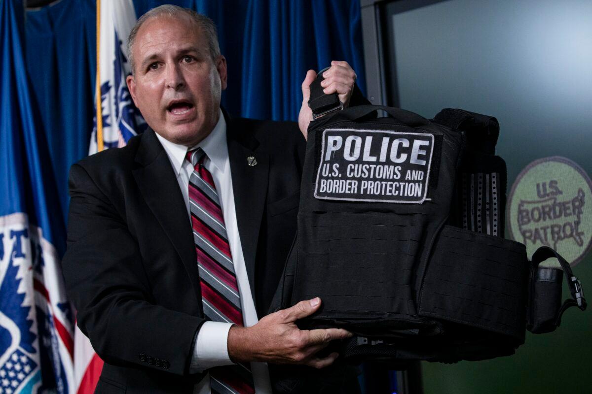 Customs and Border Protection Commissioner Mark Morgan holds up a protective vest worn by Customs and Border Protection and Homeland Security agents in Portland during ongoing riots, at the agency's headquarters in Washington on July 21, 2020. (Samuel Corum/Getty Images)