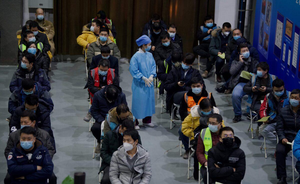 People wait to be inoculated with a COVID-19 vaccine at the Chaoyang Museum of Urban Planning in Beijing on Jan. 15, 2021. (Noel Celis/AFP via Getty Images)