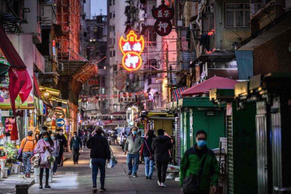 Pedestrians walked on a street in Kowloon's Jordan district in Hong Kong on Jan. 20, 2021. (ANTHONY WALLACE/ Getty Images)