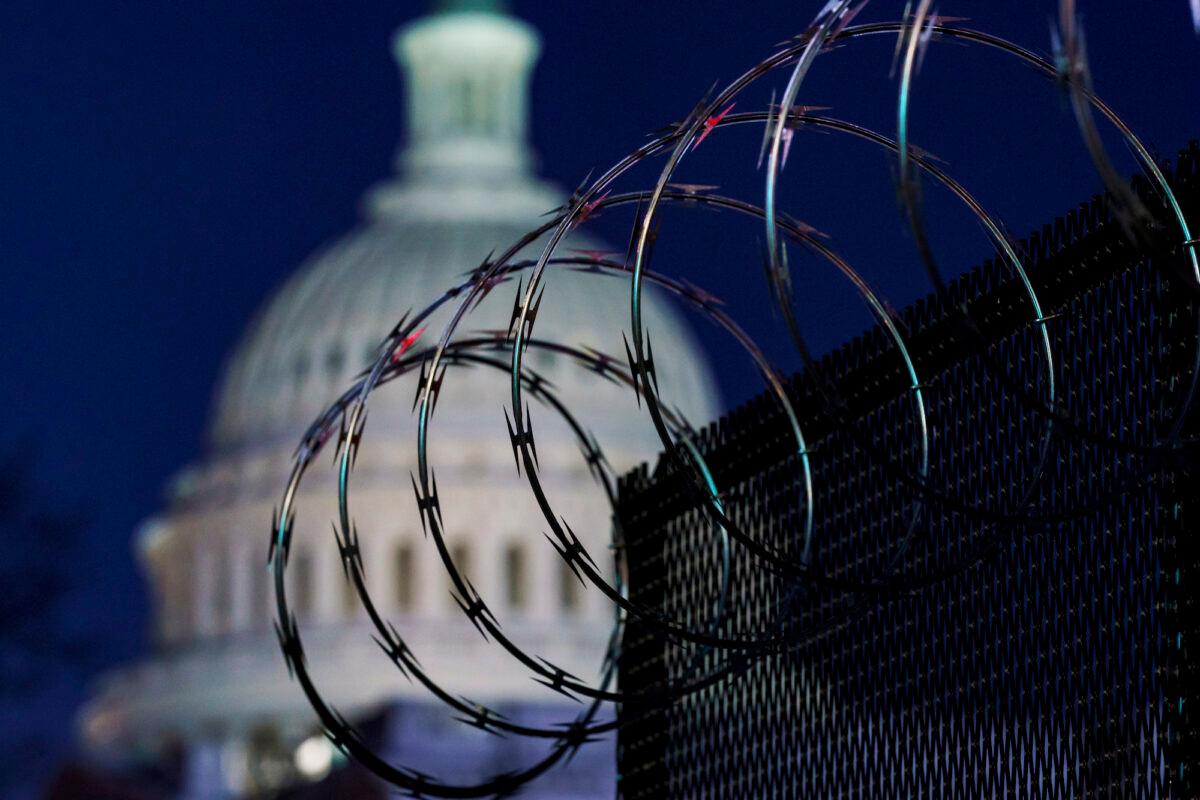 Riot fencing and razor wire reinforce the security zone on Capitol Hill, in Washington, on Jan. 19, 2021. (AP Photo/J. Scott Applewhite)