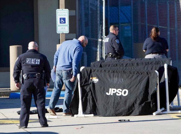 Jefferson Parish Sheriff's Office deputies investigate a shooting at the Jefferson Gun Outlet in Metairie, La., on Feb. 20, 2021. (Sophia Germer/The Times-Picayune/The New Orleans Advocate via AP)