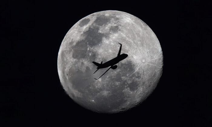 Photographer Shooting Full Moon Accidentally Snaps Passenger Jet Flying Across Silvery Lunar Sphere