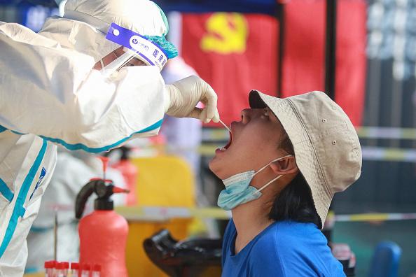 Amid the country's most widespread coronavirus outbreak in months, a resident receives a nucleic acid test for the Covid-19 coronavirus in Yangzhou in China's eastern Jiangsu Province, on Aug. 1, 2021. (STR/AFP via Getty Images/China OUT )