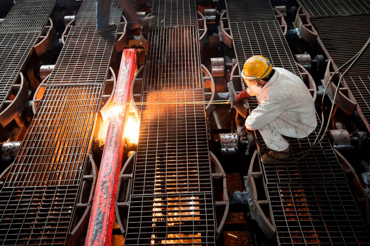 A worker makes an iron bar at a steel factory in Lianyungang, in China's Jiangsu Province, on Feb. 12, 2021. (AFP via Getty Images)