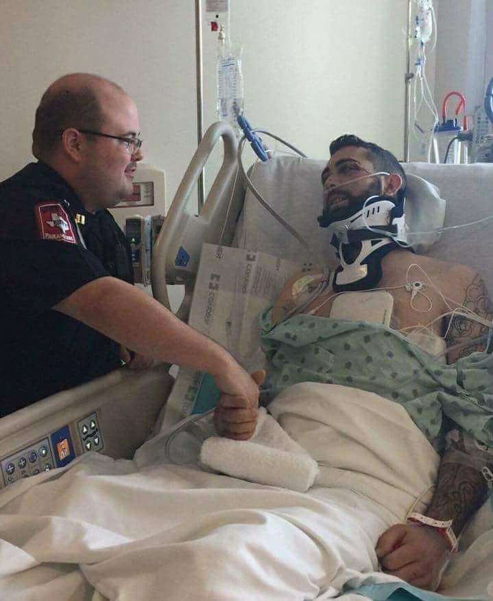 Caleb shaking hands with the officer who helped keep his chest open to relieve air before he was taken to the hospital. Both of them have developed a unique friendship since then. (Courtesy of <a href="https://www.instagram.com/calebtrahan/">Caleb Trahan</a>)