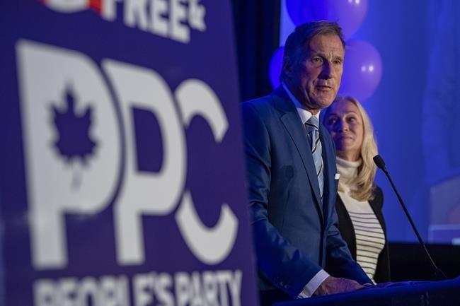 People's Party of Canada Leader Maxime Bernier and wife Catherine Letarte speaks to supporters during the PPC headquarters election night event in Saskatoon, Sask., Sept. 20, 2021. (The Canadian Press/Liam Richards)