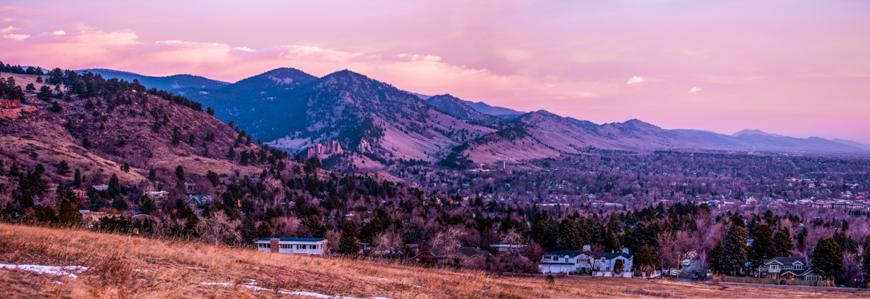 Boulder Colorado waking- up with the morning light on the town, and the Flatirons on the front range, and the Rocky Mountains in the background. (Cat Rooney)
