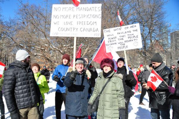 Peter Karandysovsky (centre, holding sign) takes part in demonstrations against COVID-19 mandates and restrictions on the grounds of the Ontario legislature in Toronto on Feb. 5, 2022. (Allen Zhang/The Epoch Times)