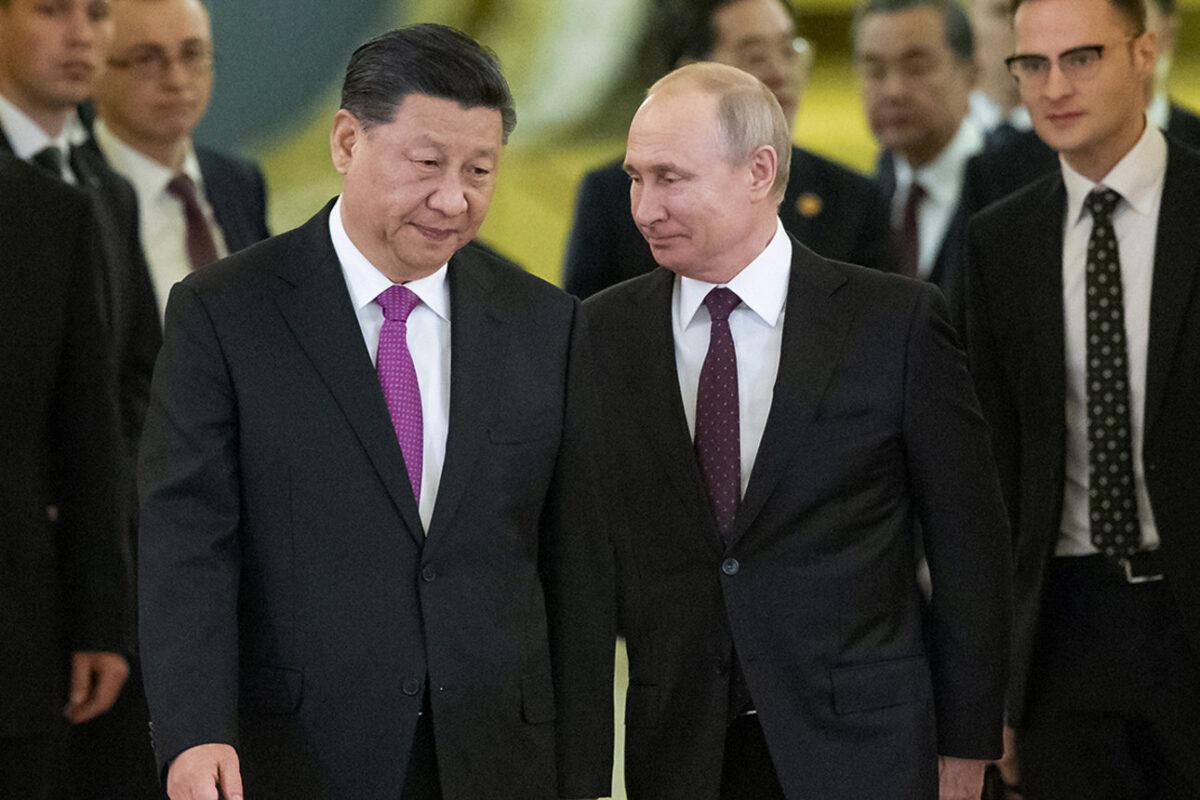 Chinese leader Xi Jinping and Russian President Vladimir Putin enter a hall for talks in the Kremlin in Moscow, in this 2019 file photo. (Alexander Zemlianichenko/AP Photo)