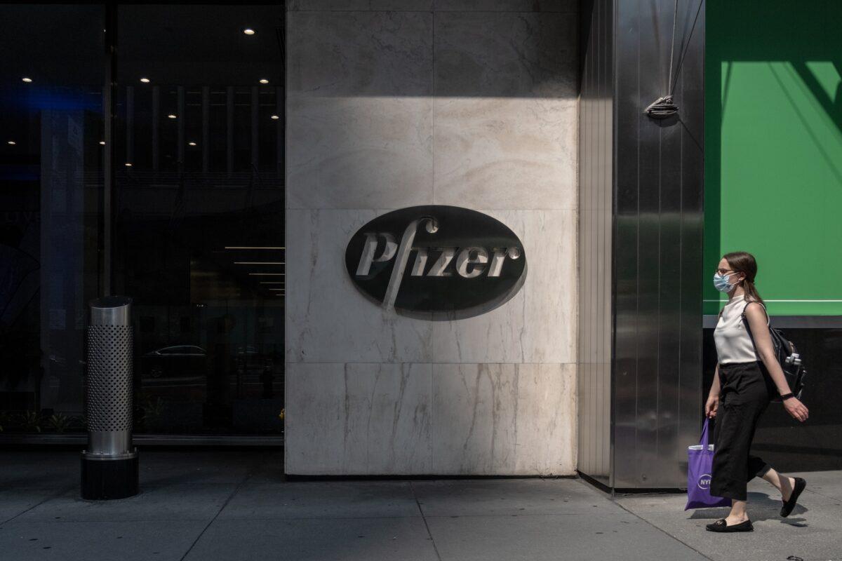 A pedestrian walks by Pfizer's New York City headquarters in a file photograph. (Jeenah Moon/Getty Images)