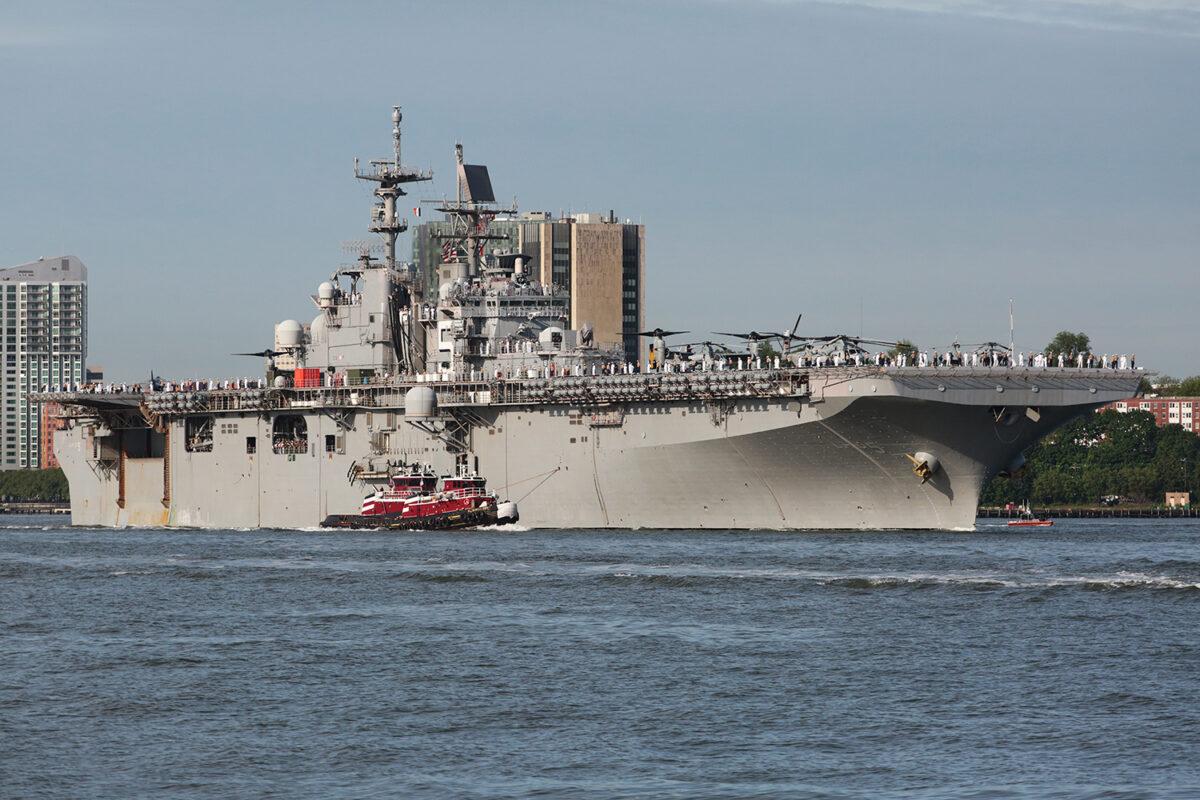 The USS Bataan is escorted by one of several tugs to her dock at Manhattan's Pier 88, in a file photo. (Richard Moore/The Epoch Times)