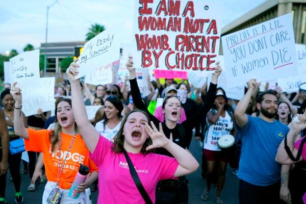 Protesters shout as they join thousands marching around the Arizona Capitol in Phoenix after the Supreme Court decision to overturn the landmark Roe v. Wade abortion decision on June 24, 2022. (AP Photo/Ross D. Franklin)