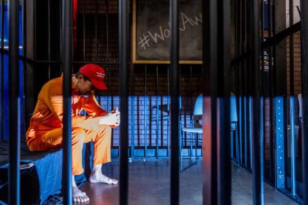 Brandon Straka sits in a simulated jail cell during a demonstration at the Conservative Political Action Conference (CPAC) held at the Hilton Anatole in Dallas, Texas, on Aug. 5, 2022. (Brandon Bell/Getty Images)