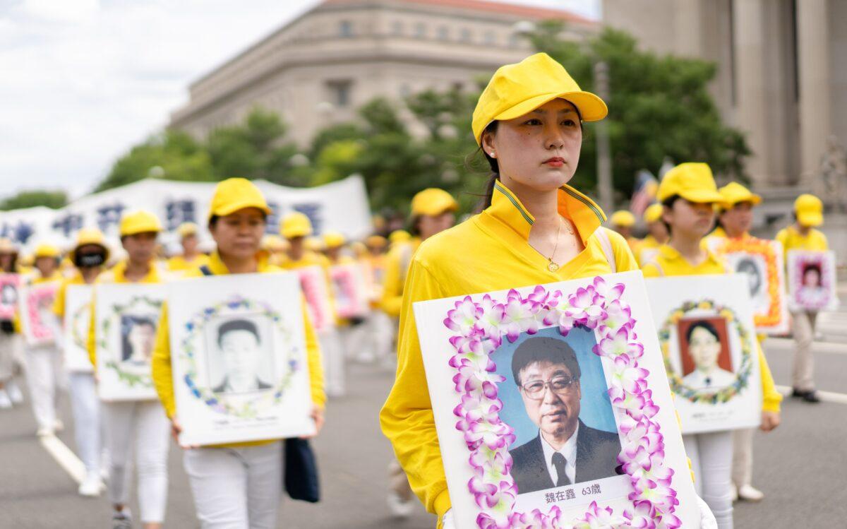 Falun Gong practitioners march down Constitution Avenue to commemorate the 23rd anniversary of the Chinese Communist Party's persecution of the spiritual practice in China, in Washington on July 21, 2022.(Samira Bouaou/The Epoch Times)