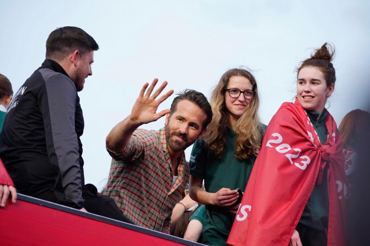 Wrexham co-owner Ryan Reynolds (C) celebrates with members of the Wrexham FC soccer team the promotion to the Football League in Wrexham, Wales, on May 2, 2023. (Jon Super/AP Photo)
