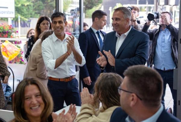Prime Minister Rishi Sunak with newly elected Conservative MP Steve Tuckwell (R) at the Rumbling Tum cafe in Uxbridge, west London, on July 21, 2023. (Carl Court/PA Media)