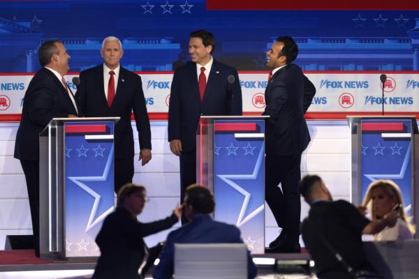 Republican presidential candidates (L-R), former New Jersey Gov. Chris Christie, former U.S. Vice President Mike Pence, Florida Gov. Ron DeSantis, and Vivek Ramaswamy speak during a break in the first debate of the GOP primary season hosted by FOX News at the Fiserv Forum in Milwaukee, Wis., on Aug. 23, 2023. (Win McNamee/Getty Images)