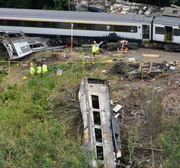 Emergency services inspect the scene near Stonehaven, Aberdeenshire, Scotland, on Aug. 13, 2020, following the derailment of the ScotRail train. (Ben Birchall/PA via AP)