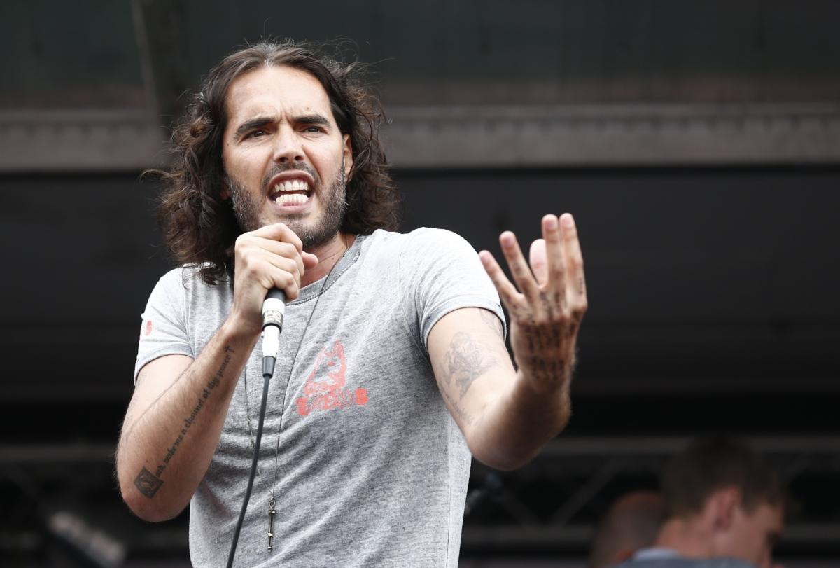 British comedian Russell Brand speaks to protesters following a march against the British government's spending cuts and austerity measures in London on June 20, 2015. (Justin Tallis/AFP via Getty Images)