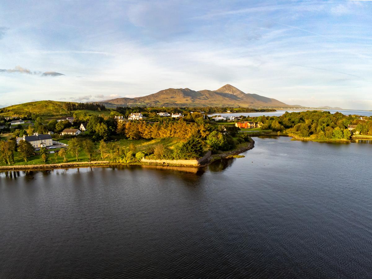 Croagh Patrick, a mountain and important pilgrimage site in County Mayo, stands in the background as the sun rises on Westport, Ireland. (lisandrotrarbach/Getty Images)