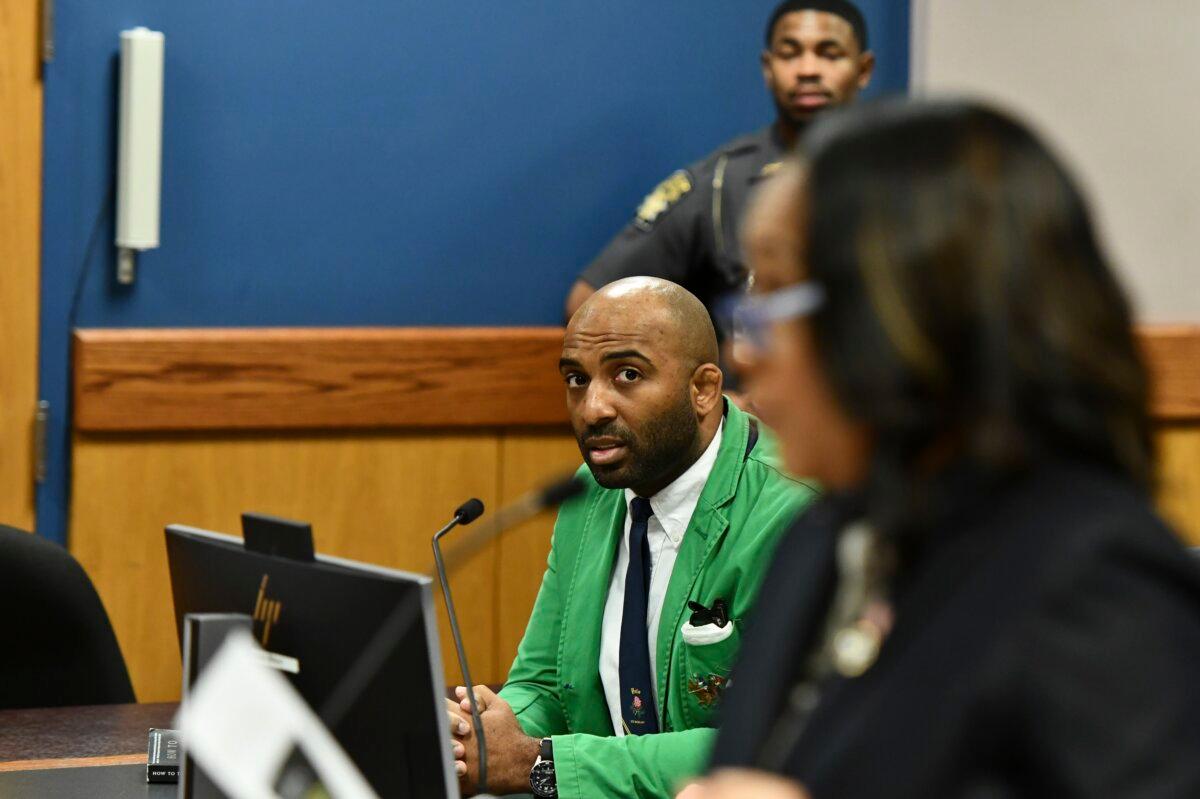 Defendant Harrison Floyd (L), a leader in the organization Black Voices for Trump, listens as Fulton County District Attorney Fani Willis addressed the court during a hearing related to the Georgia election indictments in Atlanta on Nov. 21, 2023. (Dennis Byron/Hip Hop Enquirer via AP)