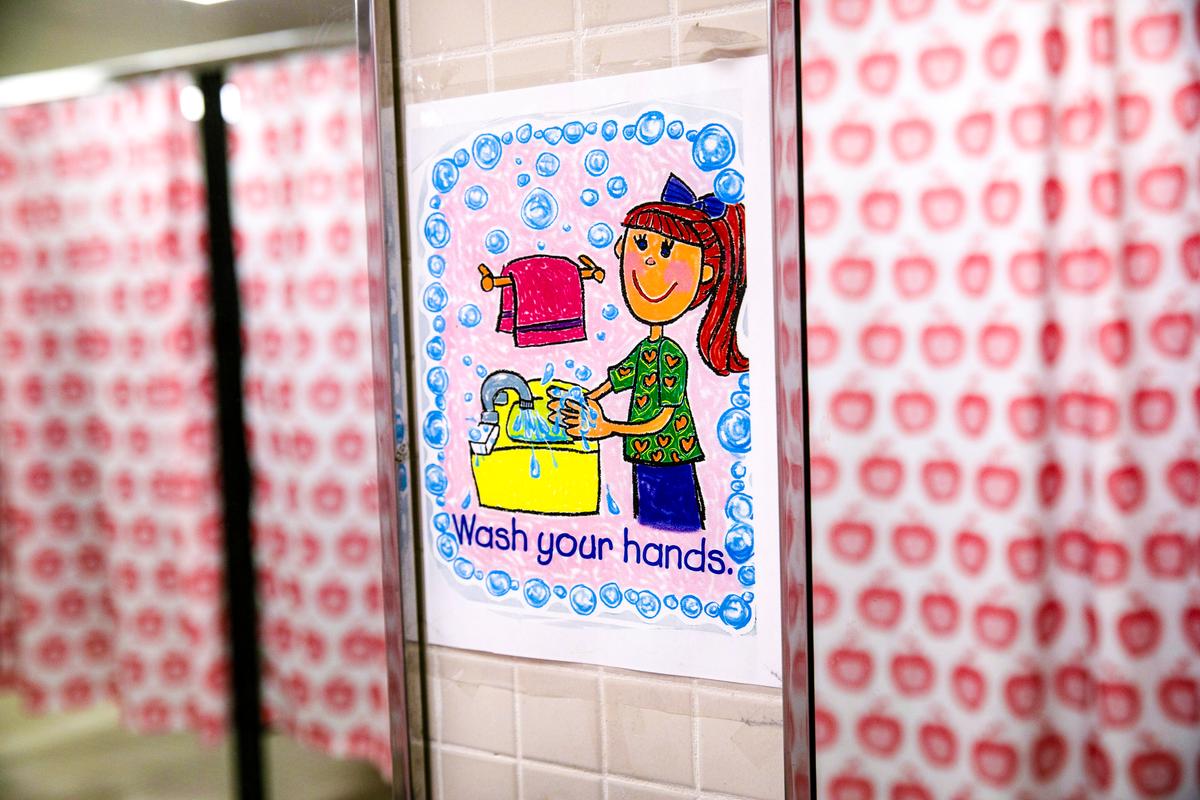 A hand-washing sign hangs in a girls' bathroom at a school in Stamford, Conn., on Aug. 26, 2020. (John Moore/Getty Images)