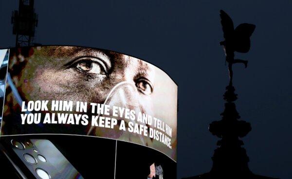 COVID-19 messaging is seen on the advertising hoarding at Piccadilly Circus during the UK's third national lockdown, in London, on Feb. 3, 2021. (Chris Jackson/Getty Images)