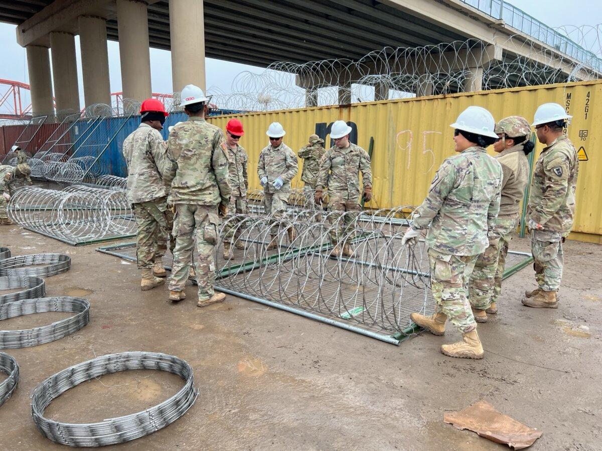 Texas National Guard members work to put up more barriers at Shelby Park on the U.S.–Mexico border, in Eagle Pass, Texas, on Jan. 23, 2024. (Charlotte Cuthbertson/The Epoch Times)