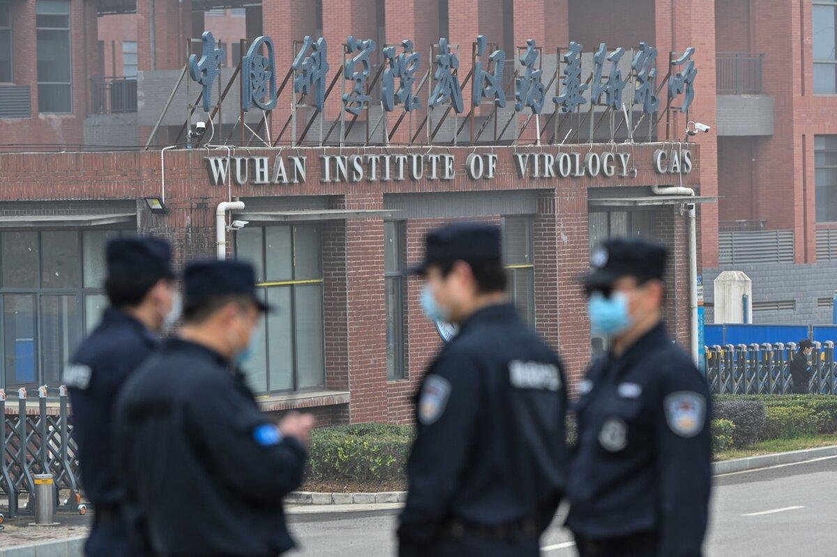 Security personnel stand guard outside the Wuhan Institute of Virology in Wuhan as members of the World Health Organization (WHO) team investigating the origins of the COVID-19 coronavirus make a visit to the institute in Wuhan in China's central Hubei province on Feb. 3, 2021. (Hector Retamal/AFP via Getty Images)