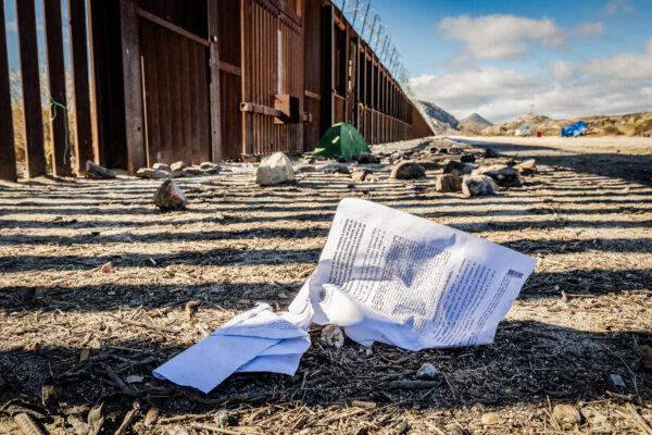 Immigration paperwork sits near the United States border wall in Jacoumba, Calif., on Jan. 10, 2024. (John Fredricks/The Epoch Times)