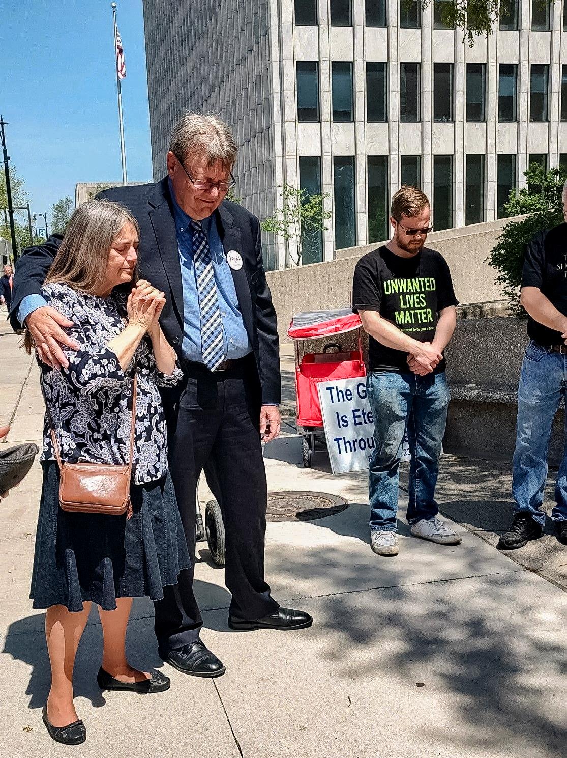 Trish and Calvin Zastrow, along with supporters, pray before entering court in Grand Rapids, Mich., on May 11, 2023. (Courtesy of Cal Zastrow)