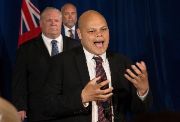 Jamil Jivani, then-Ontario's Advocate for Community Opportunities, speaks as Ontario Premier Doug Ford, and Then-Minister of Children, Community, and Social Services Todd Smith listen in Toronto on June 4, 2020. (The Canadian Press/Rick Madonik-Pool)