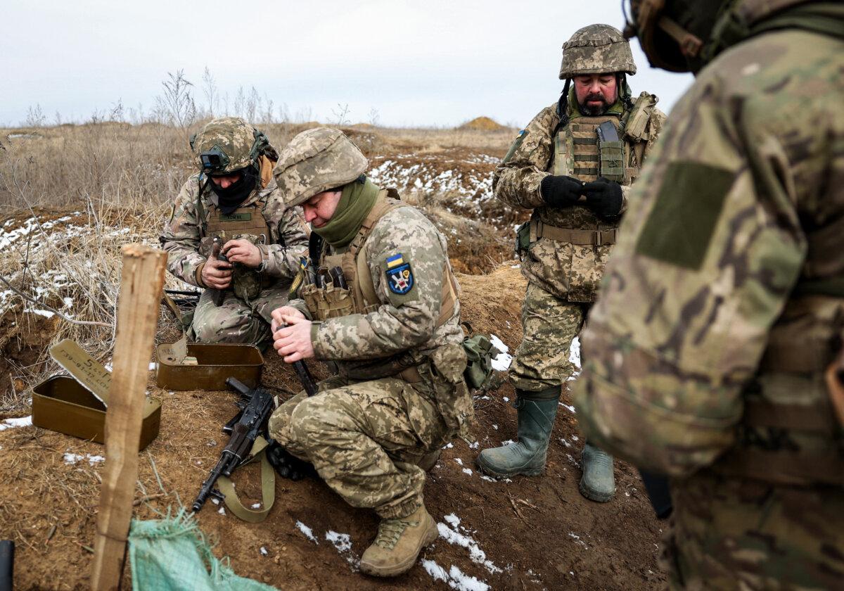 Ukrainian servicemen prepare their weapons during a military training exercise near the front line in the Donetsk region, on Feb. 23, 2024.(Anatolii Stepanov/AFP via Getty Images)