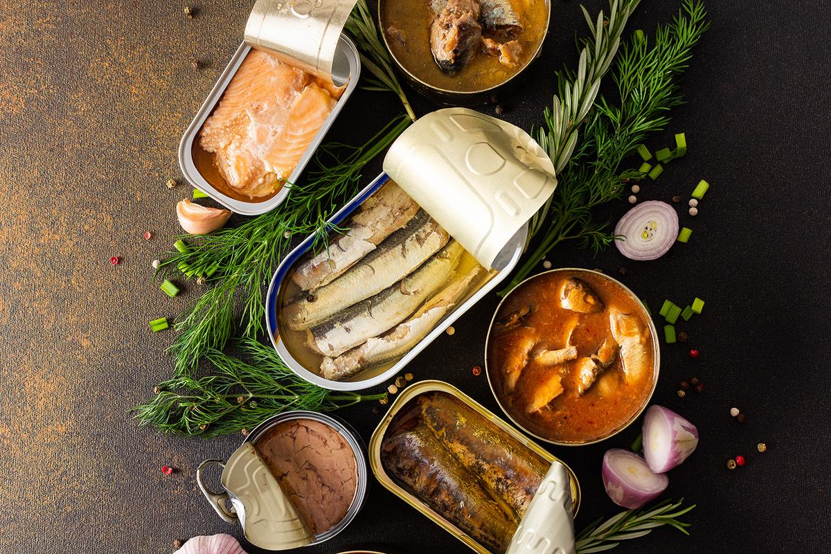 An assortment of canned salmon, mackerel, sprat, sardine, tuna, and fish pate. Eating canned fish is an easy way to include omega-3 fatty acids and vitamin D in your diet. (pundapanda/Adobe Stock)