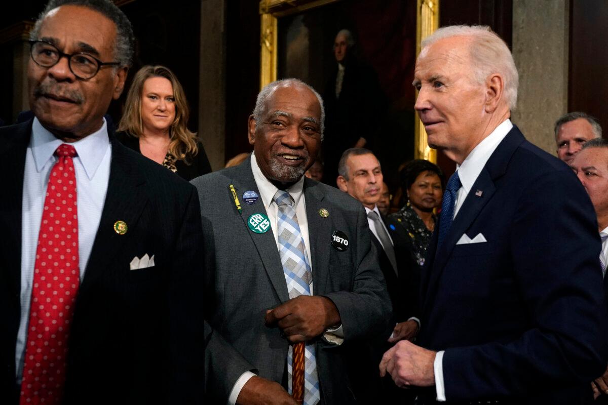 President Joe Biden talks with Rep. Danny Davis (D-Ill.), as Emanuel Cleaver (D-Mo.) watches after the State of the Union address in the House Chamber of the U.S. Capitol in Washington, D.C., on Feb. 7, 2023. (Jacquelyn Martin /POOL/AFP via Getty Images)